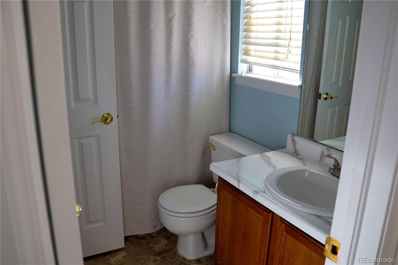 4939 East 124th Way Thornton, CO 80241 - Photo 15 of 24 a bathroom with a sink a toilet and shower