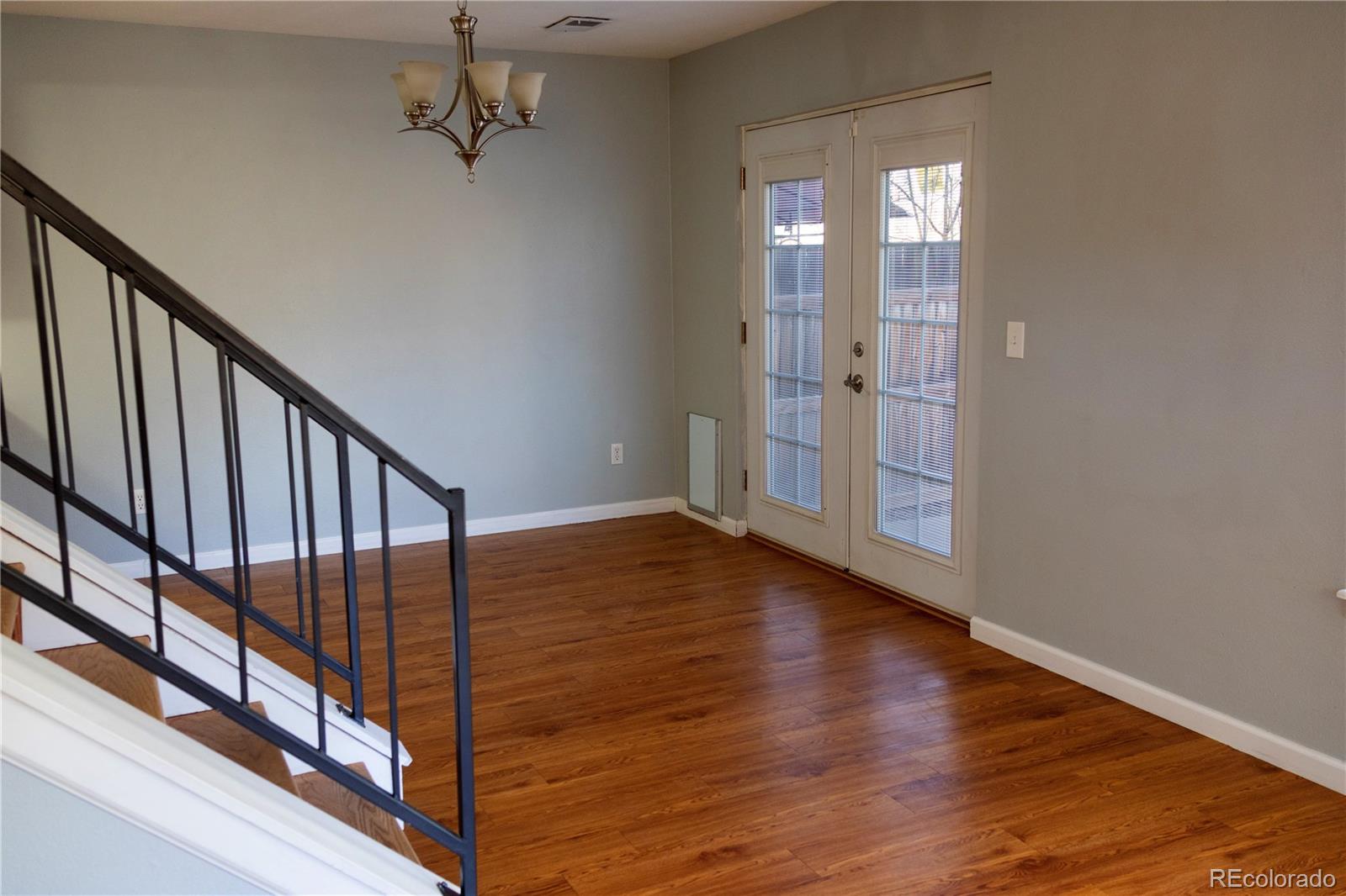 4939 East 124th Way Thornton, CO 80241 - Photo 5 of 24 a view of a hallway with wooden floor and staircase