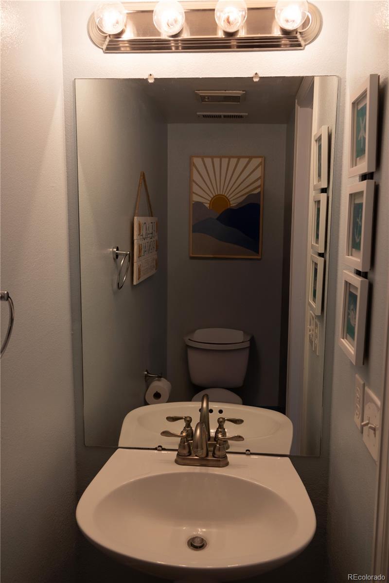 4939 East 124th Way Thornton, CO 80241 - Photo 7 of 24 a bathroom with a sink and a toilet