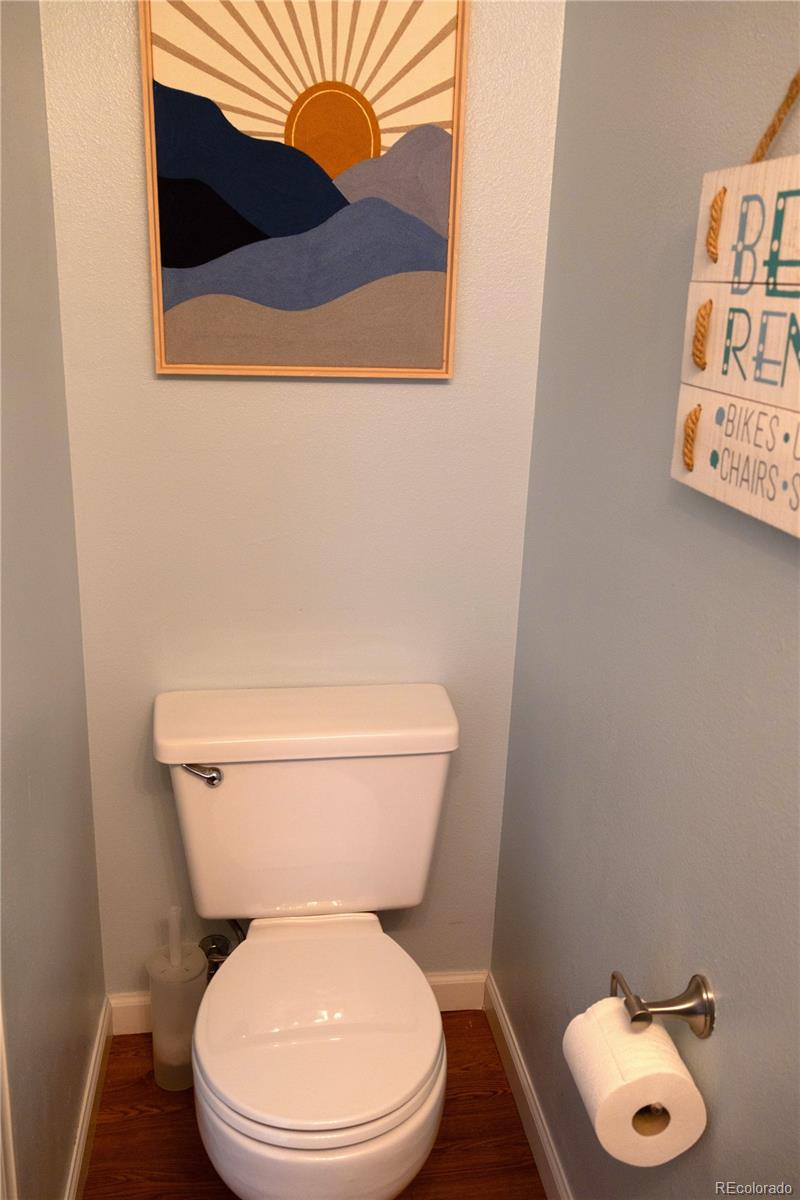 4939 East 124th Way Thornton, CO 80241 - Photo 8 of 24 a white toilet sitting next to a small bathroom
