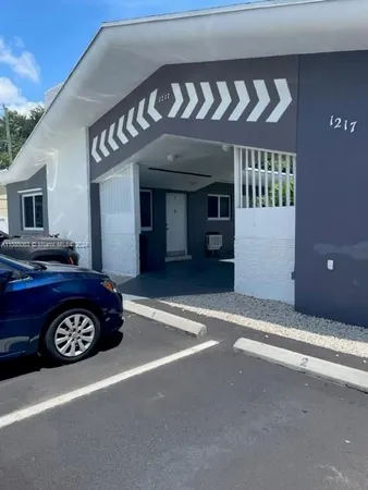 a front view of a building with parking space and a parking space