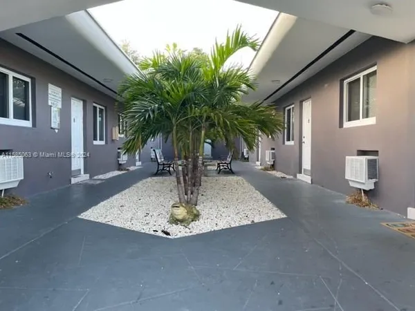 a view of a livingroom with wooden floor and ceiling fan
