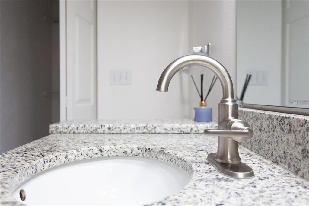 9704 Lake Chase Island Way, Unit 9704 Tampa, FL 33626 - Photo 17 of 23 a close view of a faucet a sink and a mirror