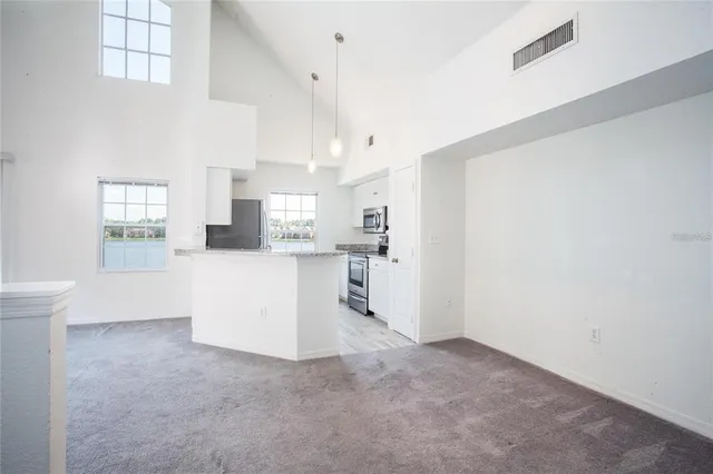 a view of a kitchen with wooden floor and windows