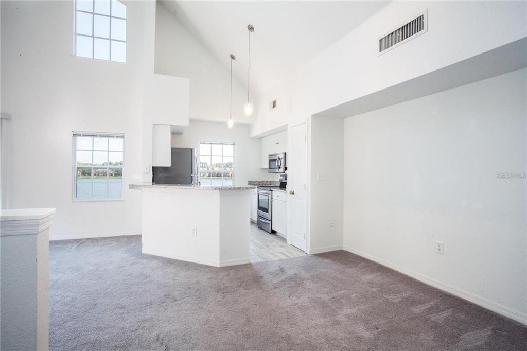 9704 Lake Chase Island Way, Unit 9704 Tampa, FL 33626 - Photo 3 of 23 a view of a kitchen with wooden floor and windows