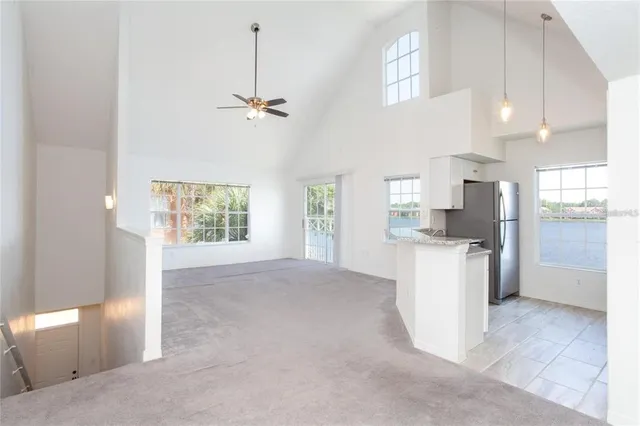 a view of kitchen with refrigerator and window