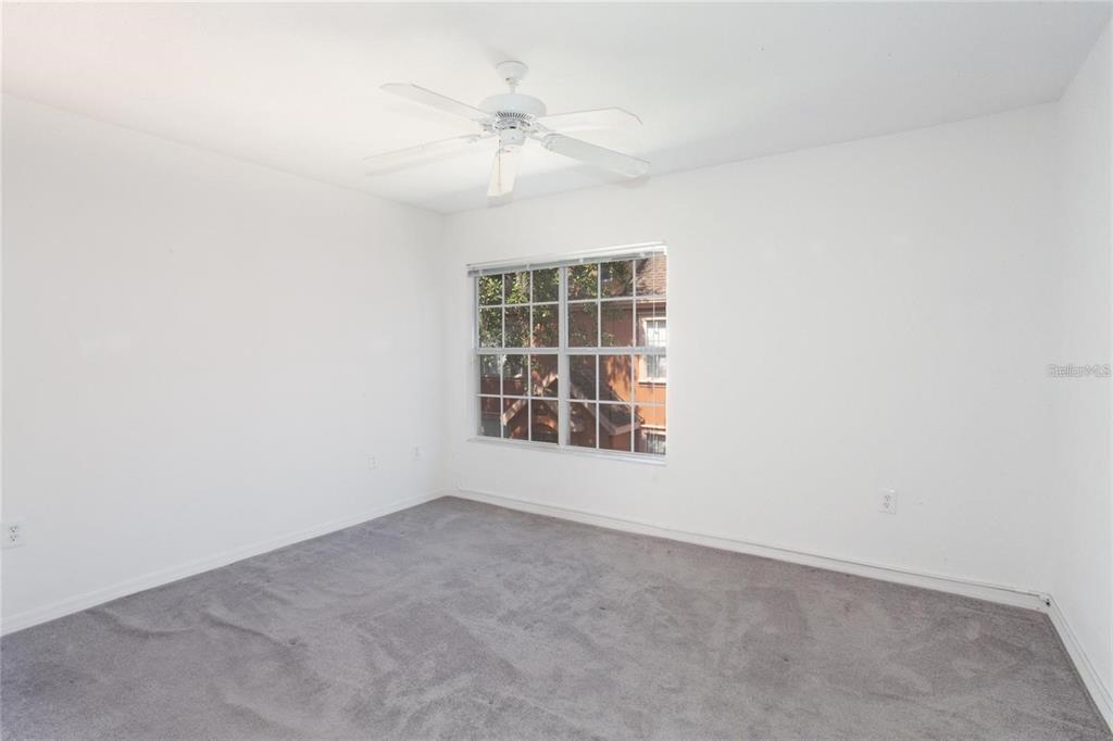 9704 Lake Chase Island Way, Unit 9704 Tampa, FL 33626 - Photo 10 of 23 an empty room with windows and fan