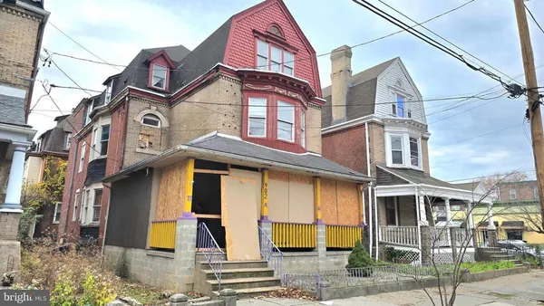 a view of a brick house with many windows