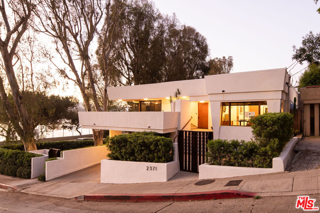 2371 Cove Avenue Los Angeles, CA 90039 - Photo 1 of 38 a view of a house with a bench next to a yard