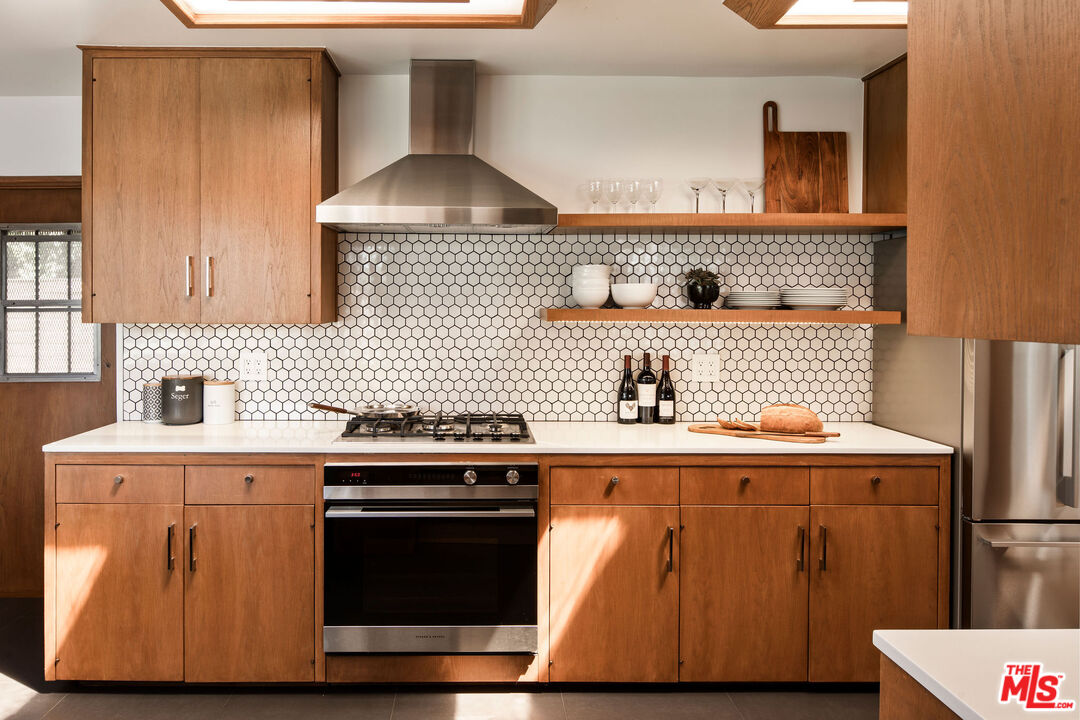 2371 Cove Avenue Los Angeles, CA 90039 - Photo 11 of 38 a kitchen with a stove and cabinets