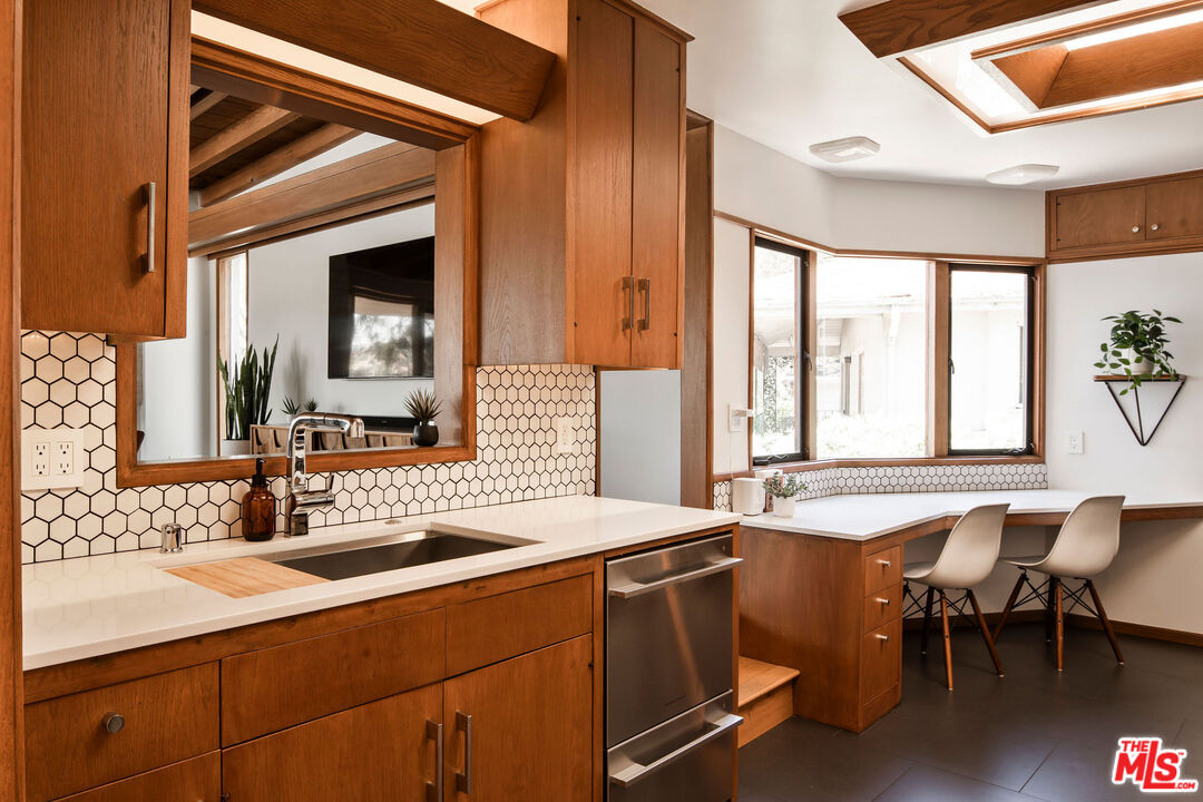 2371 Cove Avenue Los Angeles, CA 90039 - Photo 13 of 38 a kitchen with a sink cabinets and dining table