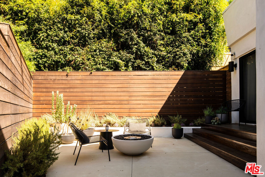 2371 Cove Avenue Los Angeles, CA 90039 - Photo 19 of 38 a view of a patio with couple of chairs and potted plants