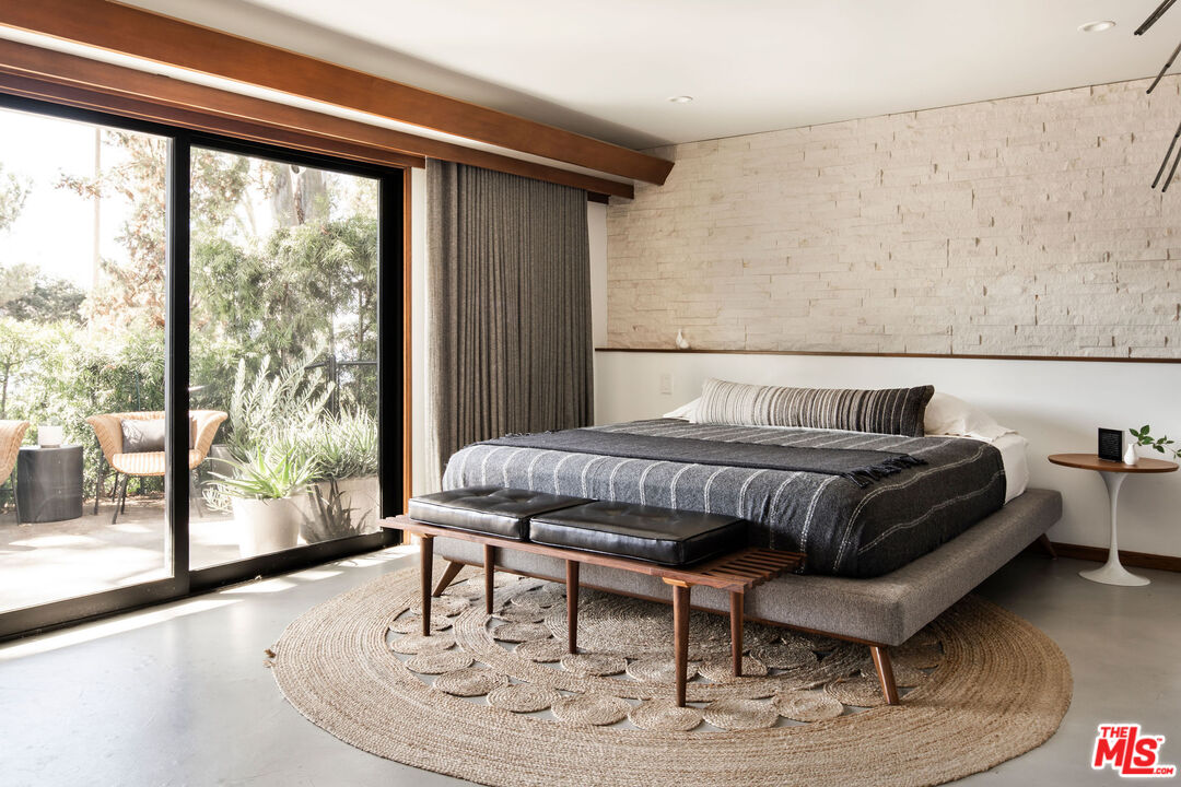 2371 Cove Avenue Los Angeles, CA 90039 - Photo 24 of 38 a bedroom with a bed and wooden floor