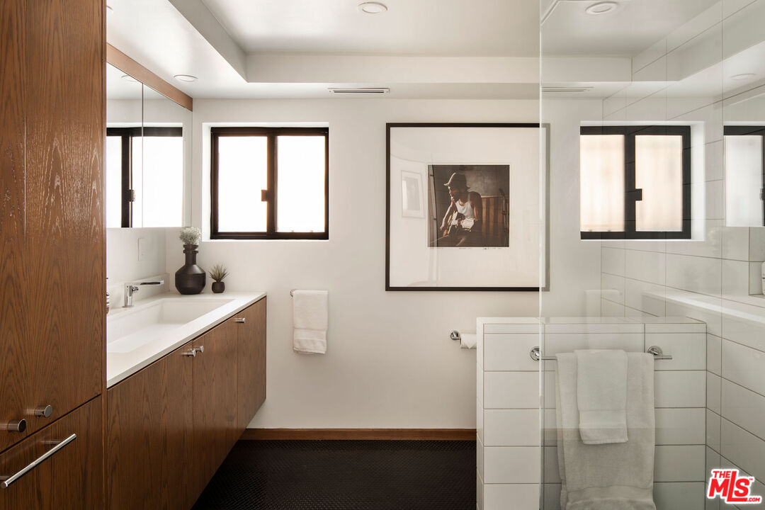 2371 Cove Avenue Los Angeles, CA 90039 - Photo 26 of 38 a hallway with a sink and mirror