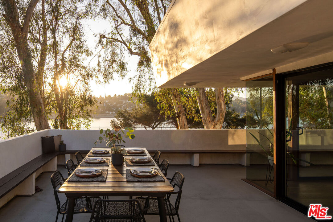 2371 Cove Avenue Los Angeles, CA 90039 - Photo 8 of 38 a view of a patio with table and chairs with wooden floor and fence