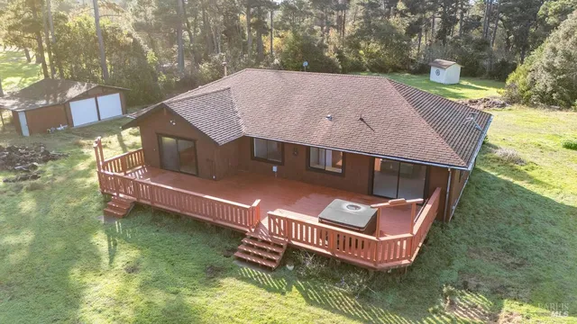 an aerial view of a house with swimming pool a yard and a fountain