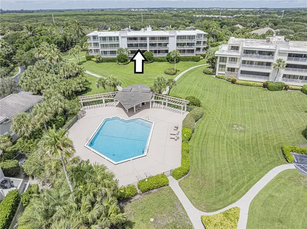a view of chairs and table on the wooden deck