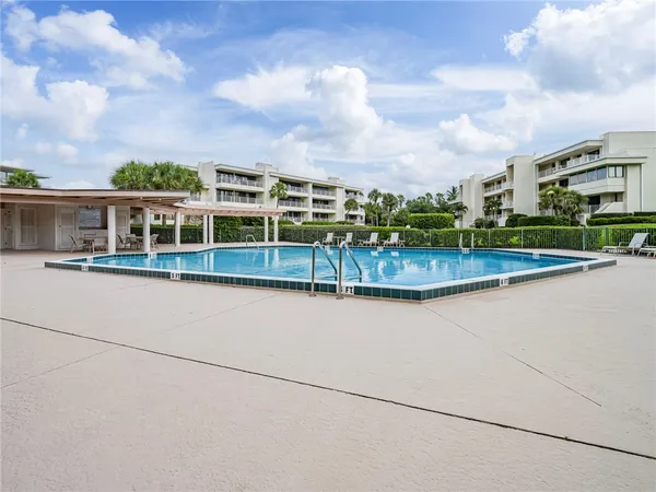 a view of a swimming pool with a yard