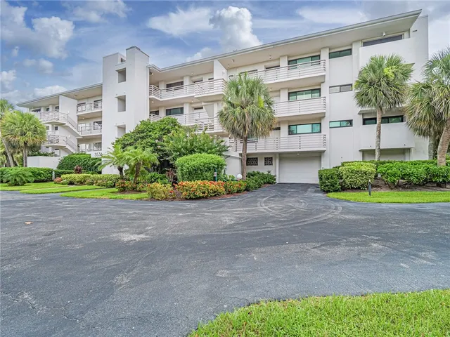 a front view of a house with a yard and a garage