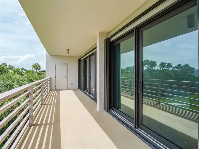 a view of balcony with wooden floor