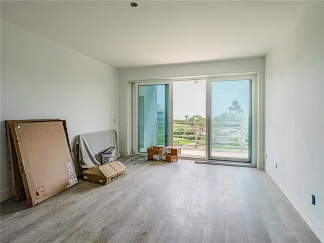 a living room with furniture and large windows