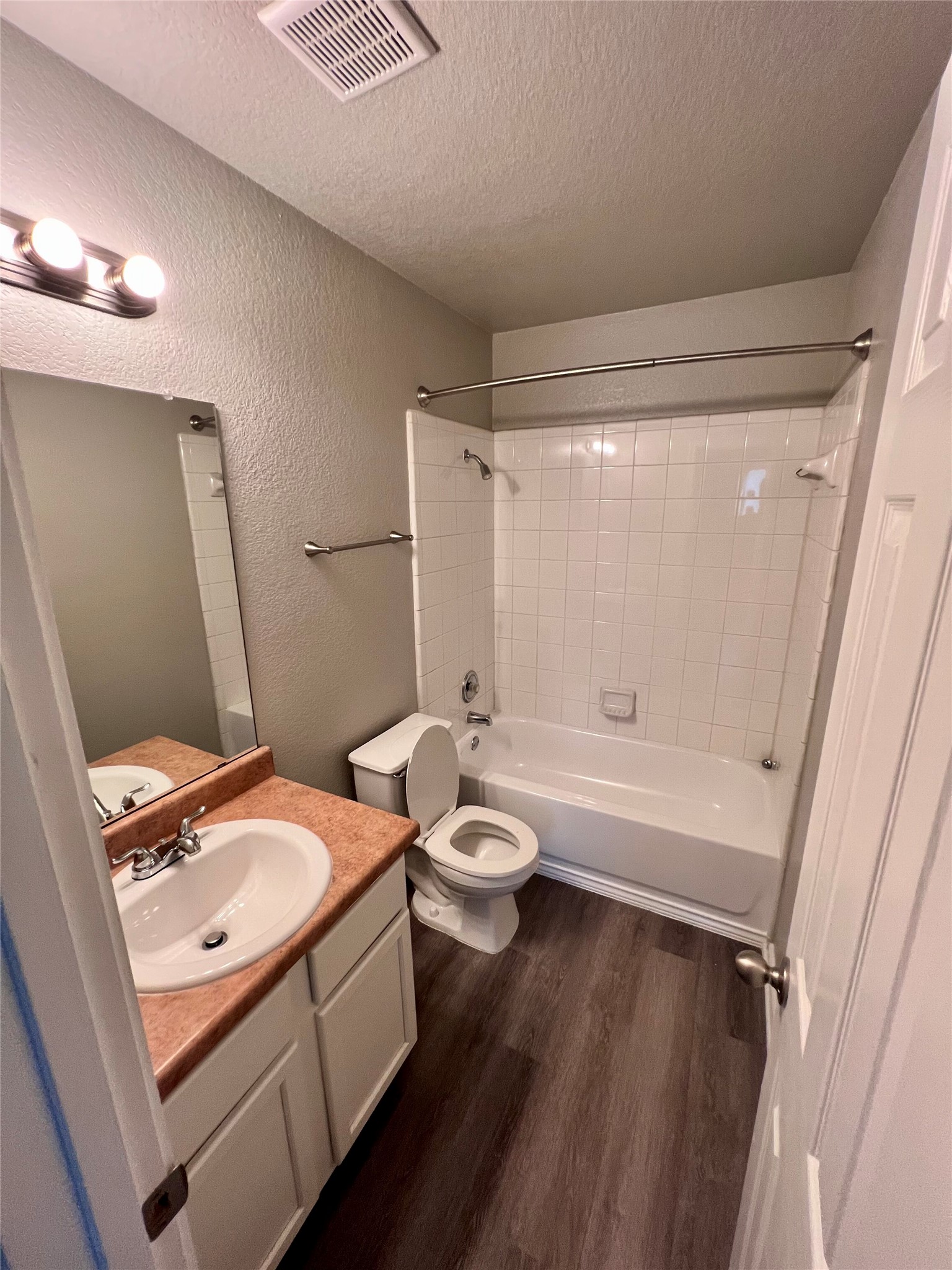 1801 Constantino Circle Austin, TX 78745 - Photo 18 of 22 a bathroom with a granite countertop sink toilet a mirror and shower