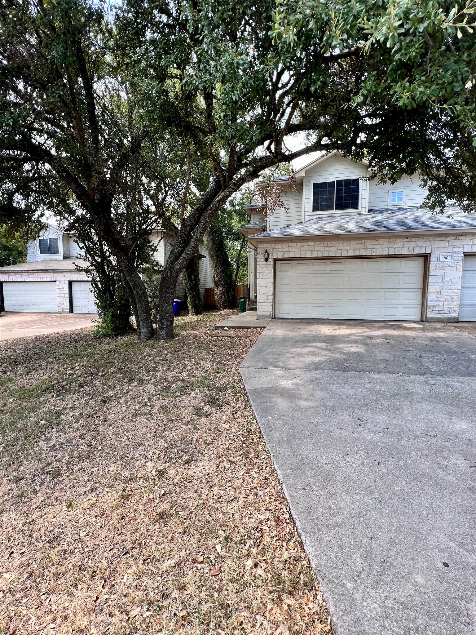 1801 Constantino Circle Austin, TX 78745 - Photo 2 of 22 a front view of a house with a yard and garage
