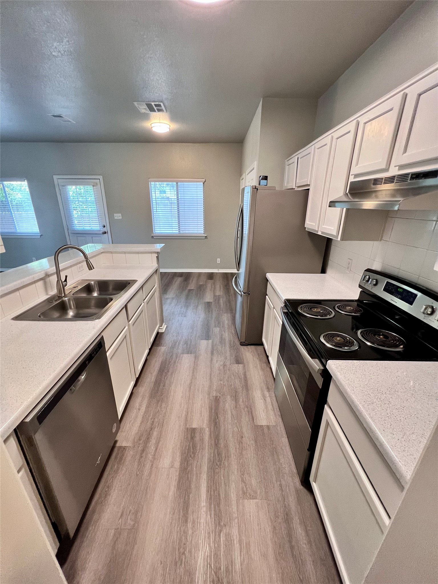 1801 Constantino Circle Austin, TX 78745 - Photo 6 of 22 a kitchen with granite countertop a sink stove and cabinets