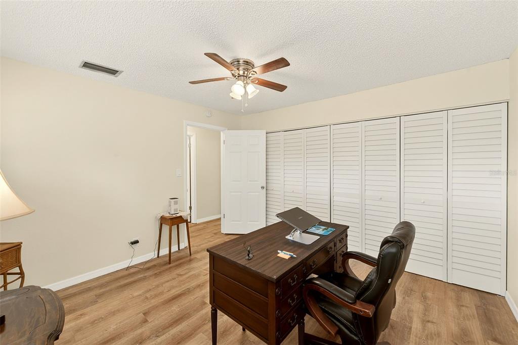 2064 Sunset Point Road, Unit 73 Clearwater, FL 33765 - Photo 32 of 58 a view of a workspace with furniture and wooden floor
