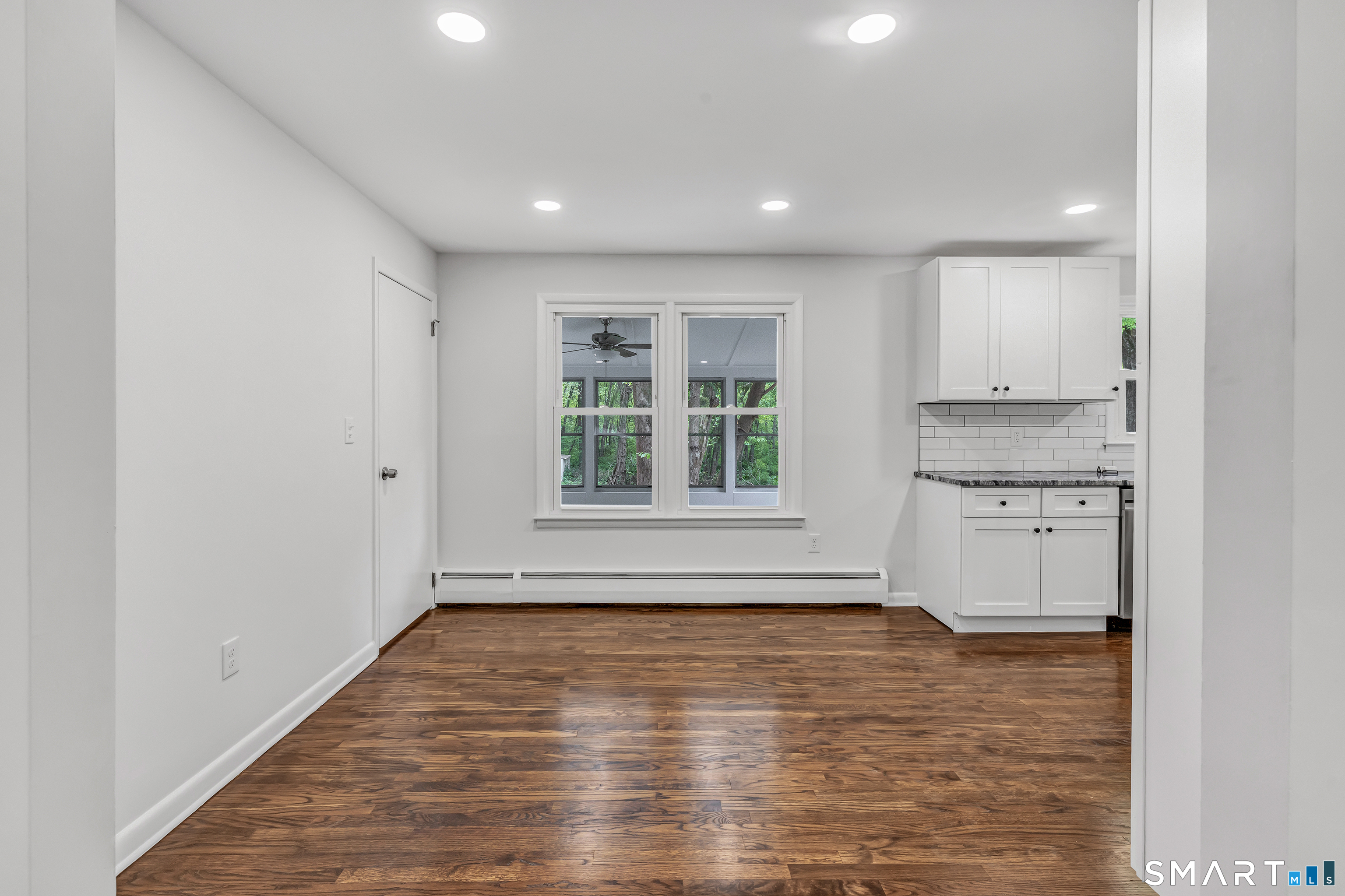 7 Longview Road Newtown, CT 06482 - Photo 7 of 40 a view of an empty room with a window and wooden floor