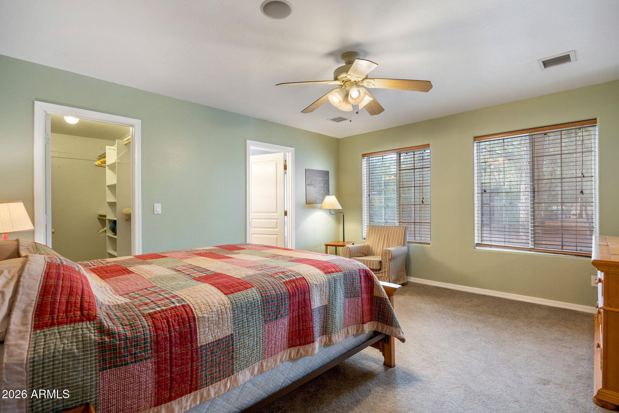 2236 Cross Country Road Overgaard, AZ 85933 - Photo 17 of 59 a bedroom with a bed and a chandelier