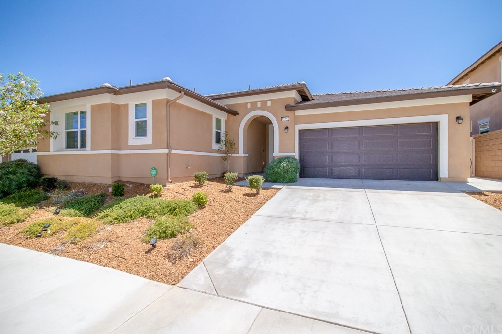 35251 Smith Avenue Beaumont, CA 92223 - Photo 1 of 33 a front view of a house with a yard and garage