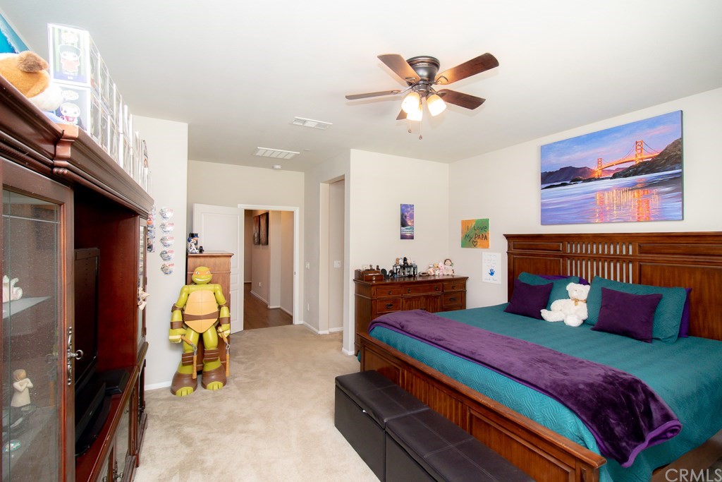 35251 Smith Avenue Beaumont, CA 92223 - Photo 16 of 33 a bedroom with furniture and a chandelier