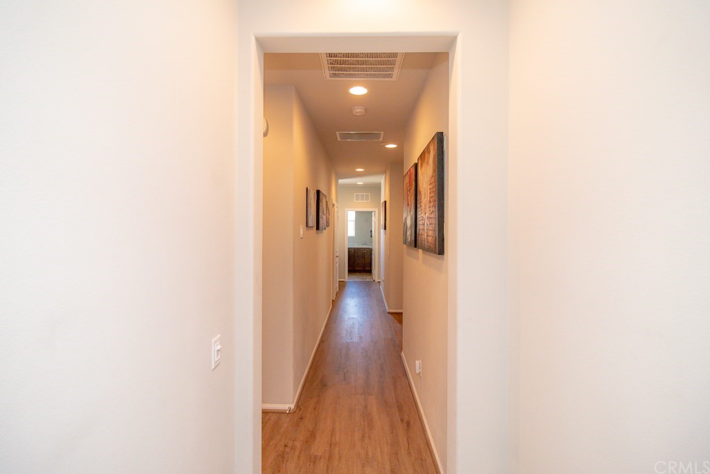35251 Smith Avenue Beaumont, CA 92223 - Photo 19 of 33 a view of a hallway with wooden floor