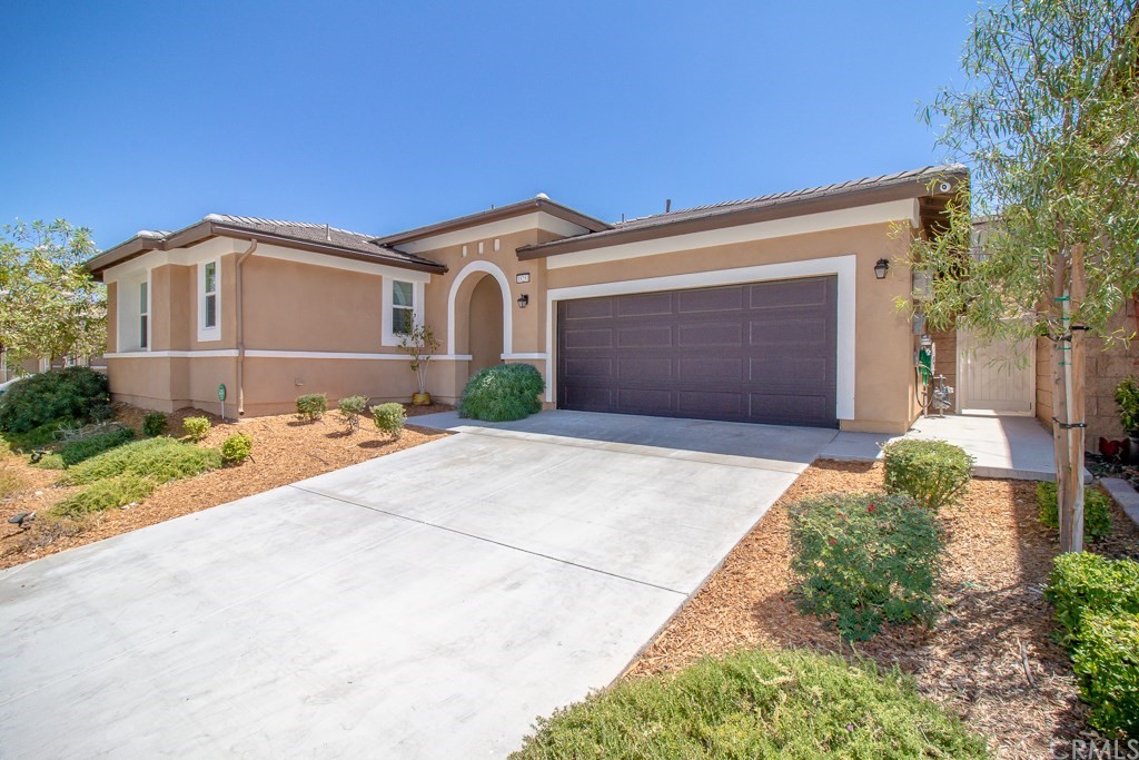 35251 Smith Avenue Beaumont, CA 92223 - Photo 2 of 33 a front view of a house with a yard and garage