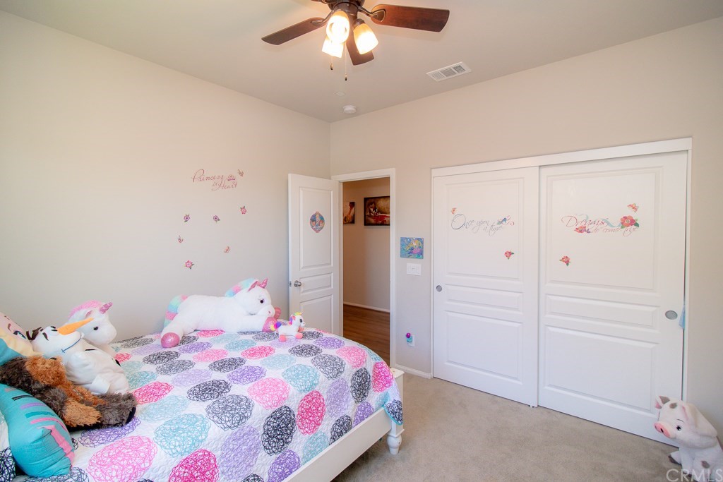 35251 Smith Avenue Beaumont, CA 92223 - Photo 23 of 33 a bedroom with a bed and a chandelier