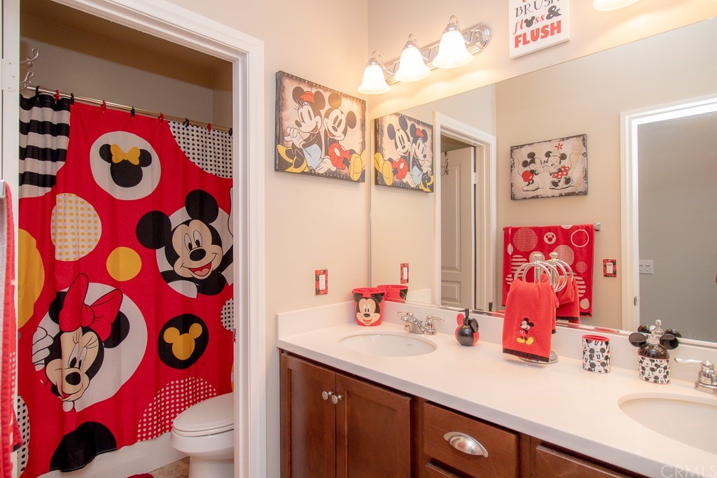 35251 Smith Avenue Beaumont, CA 92223 - Photo 27 of 33 a bathroom with a sink a toilet and vanity mirror