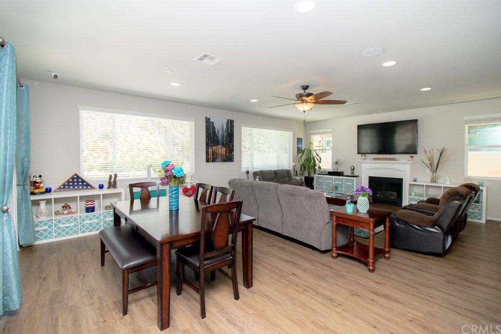 35251 Smith Avenue Beaumont, CA 92223 - Photo 6 of 33 a view of a livingroom with furniture a fireplace and wooden floor