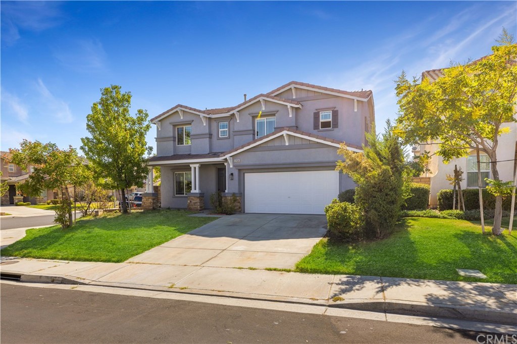 a front view of a house with a yard and garage