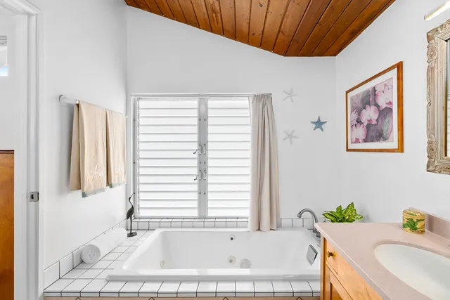 a bathroom with a tub and a sink