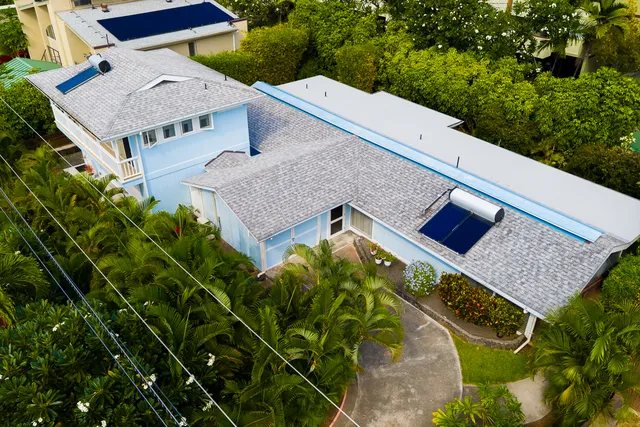 an aerial view of a house with pool garden and plants