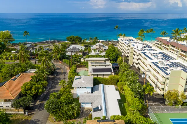 an aerial view of a house with a yard