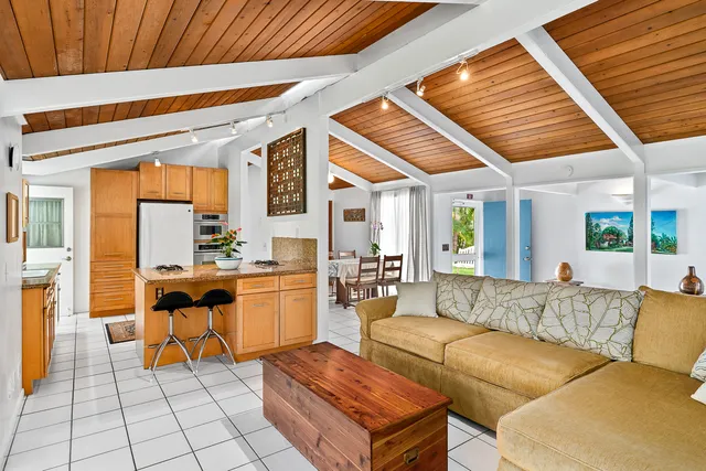 a living room with furniture and kitchen view