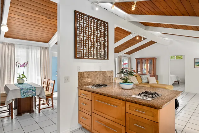 a kitchen with sink and chairs