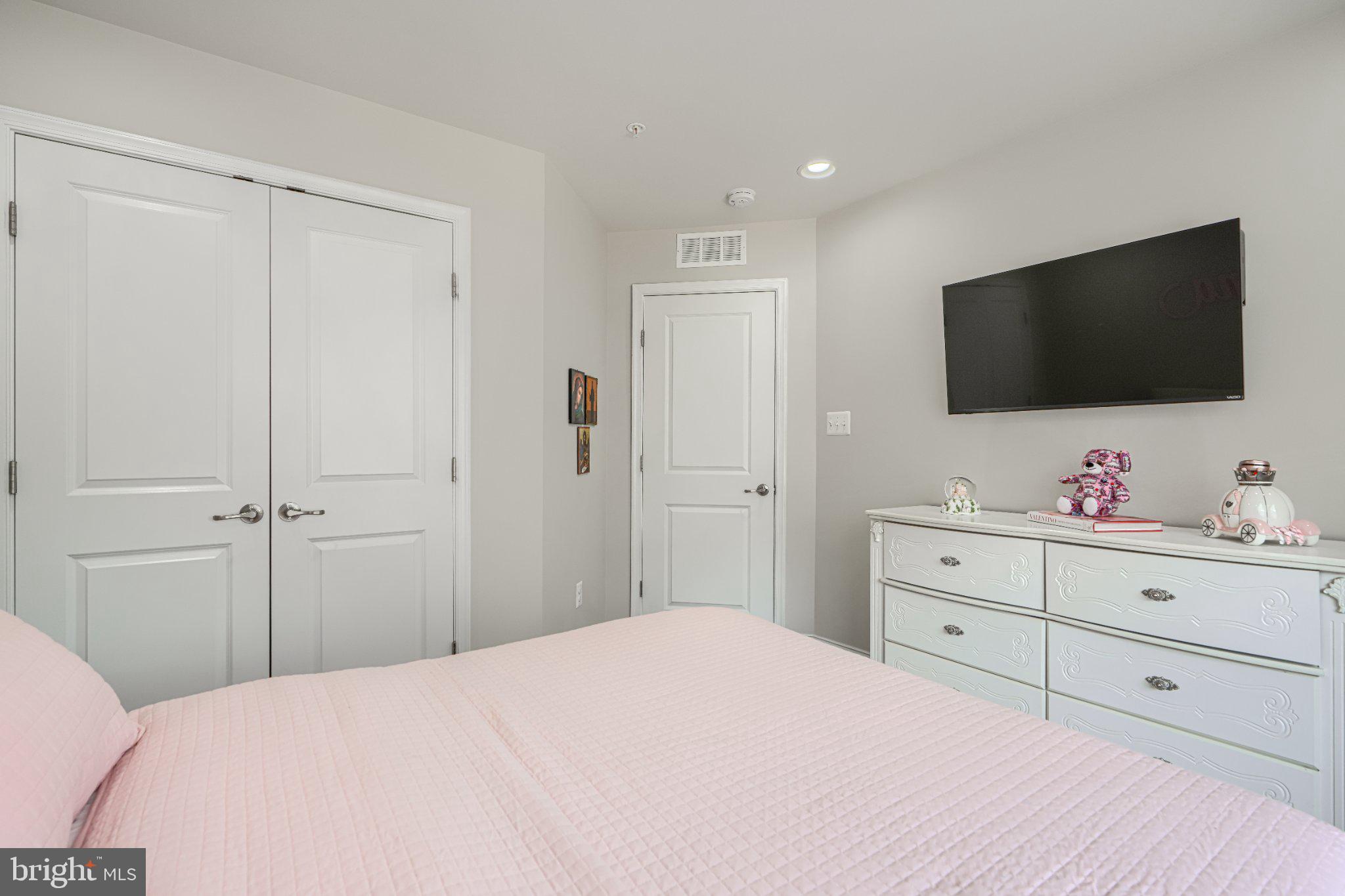 2707 Lady Slipper Road Gambrills, MD 21054 - Photo 27 of 60 a bedroom with a bed and a flat screen tv