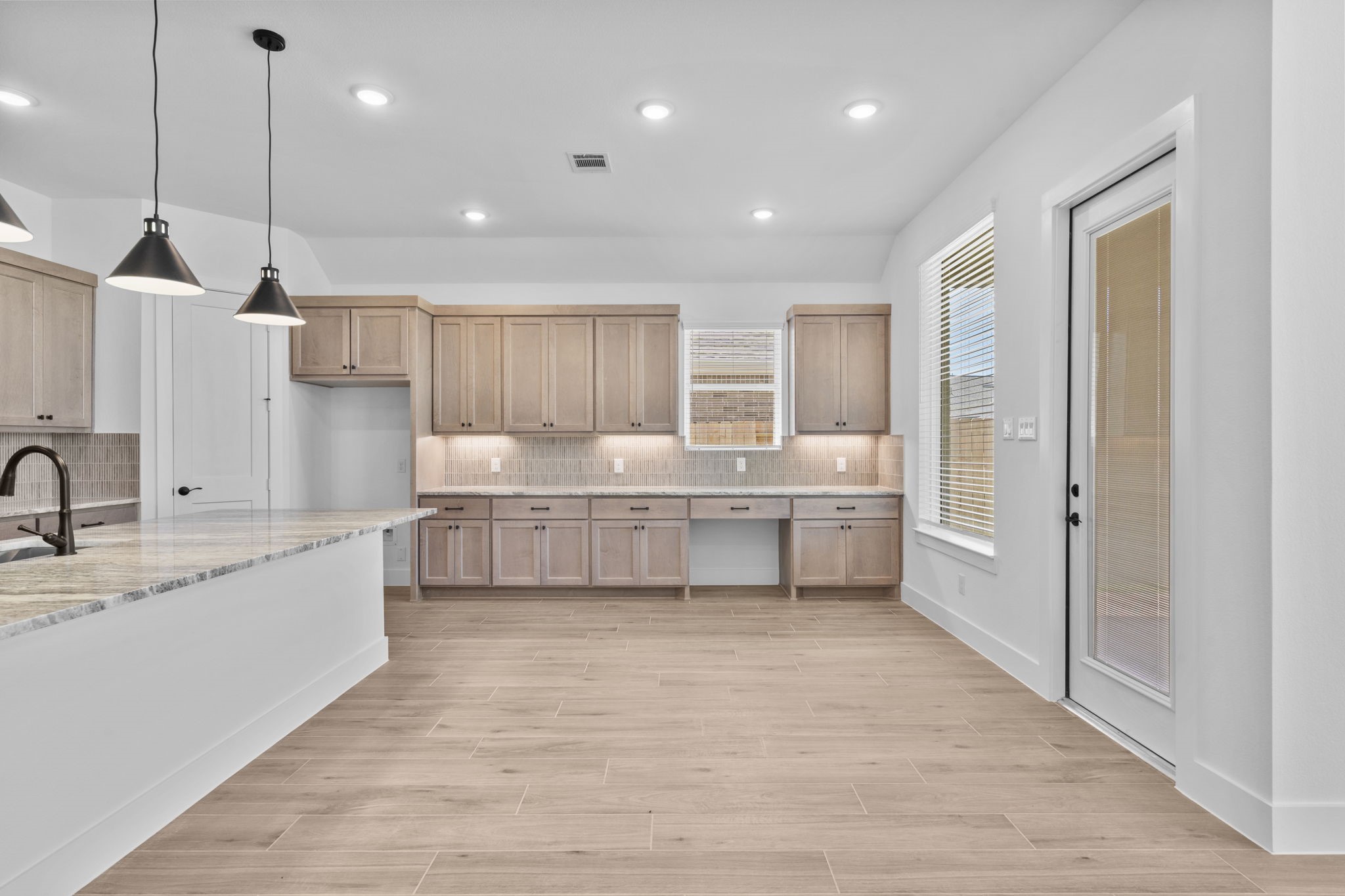 2910 Peach Vly Road Fulshear, TX 77423 - Photo 20 of 35 a large kitchen with kitchen island a sink stainless steel appliances and cabinets