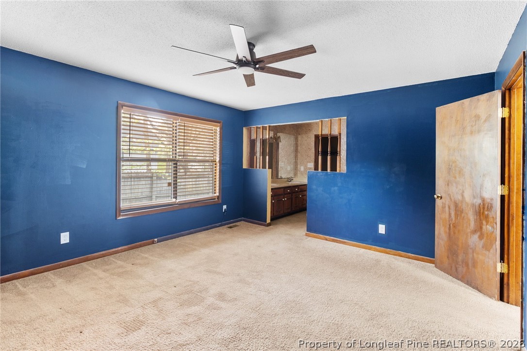 6009 Dalton Road Fayetteville, NC 28314 - Photo 18 of 36 a view of a livingroom with a ceiling fan and window