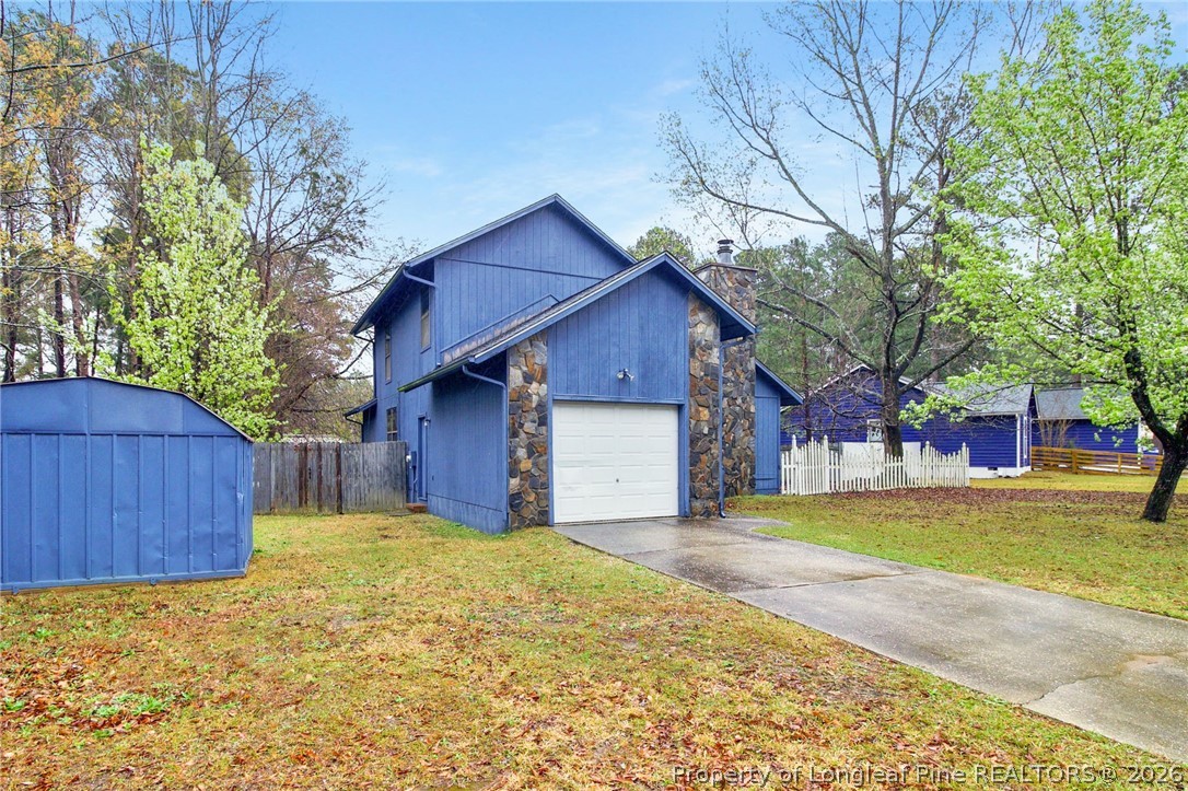 6009 Dalton Road Fayetteville, NC 28314 - Photo 3 of 36 a front view of a house with a yard and garage