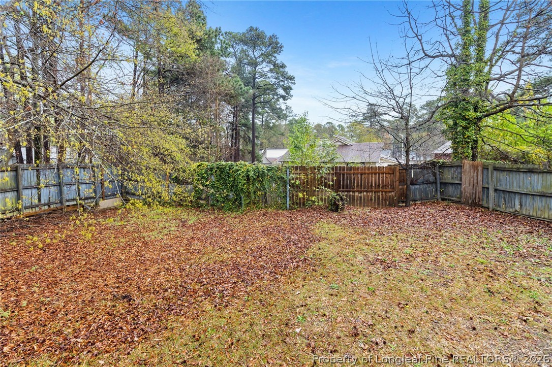 6009 Dalton Road Fayetteville, NC 28314 - Photo 36 of 36 a backyard of a house with lots of green space