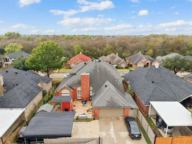 an aerial view of multiple houses with a yard